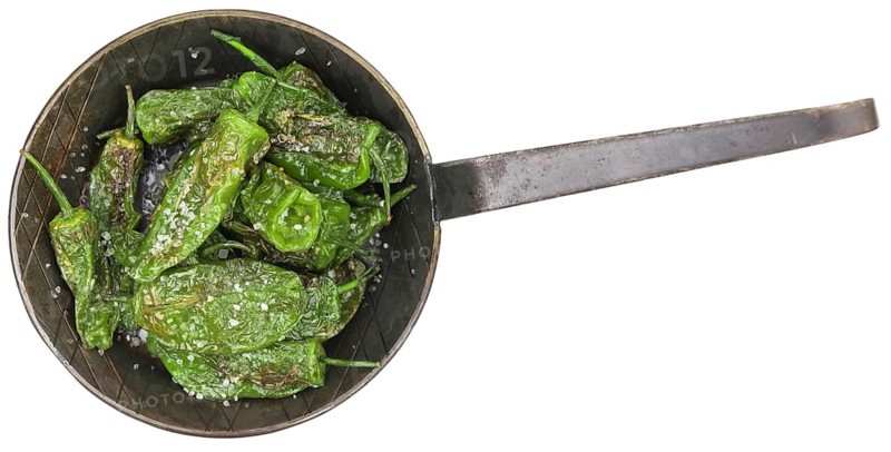 Portion of Pimientos de Padron as detailed close-up shot isolated on white background