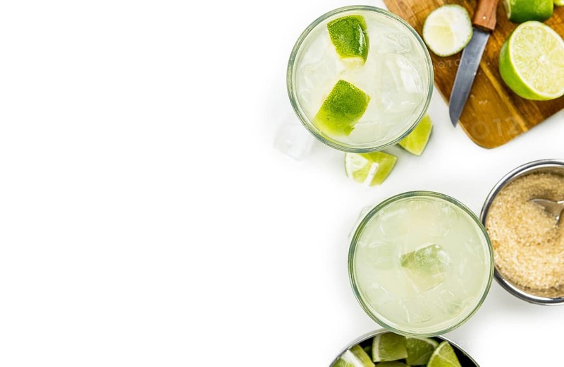 Caipirinha isolated on white background (selective focus, close-up shot)