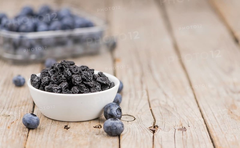 Fresh made Dried Blueberries on a vintage background as detailed close-up shot