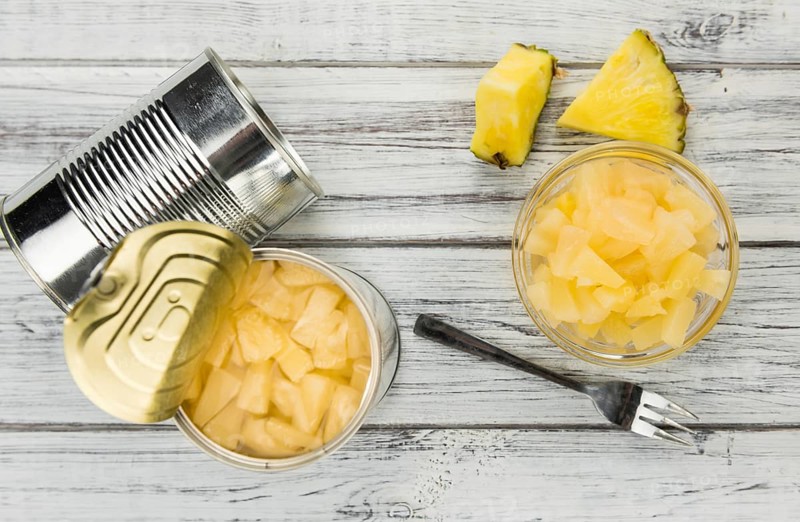Preserved Pineapple pieces on a vintage background as detailed close-up shot, selective focus