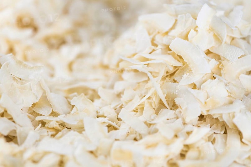 Fresh Coconut Flakes as detailed close-up shot (selective focus)