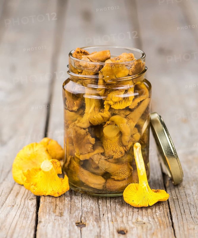 Canned chanterelles on a vintage background as detailed close-up shot, selective focus
