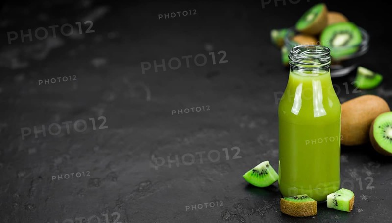 Kiwi Smoothie (selective focus) on an old and vintage background (homemade)