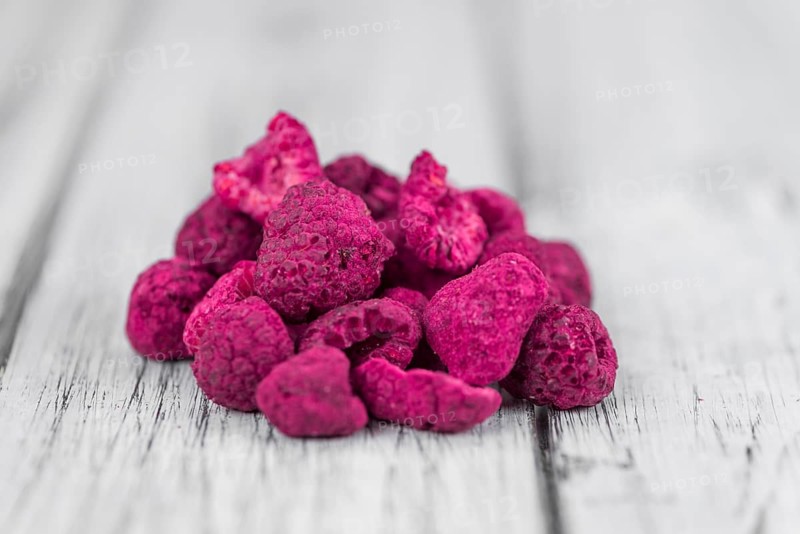 Fresh made Raspberries (dried) on an old and rustic wooden table, selective focus, close-up shot