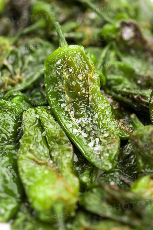 Portion of fresh Pimientos de Padron close-up shot, selective focus