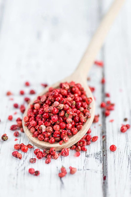Portion of fresh Pink Peppercorns close-up shot, selective focus