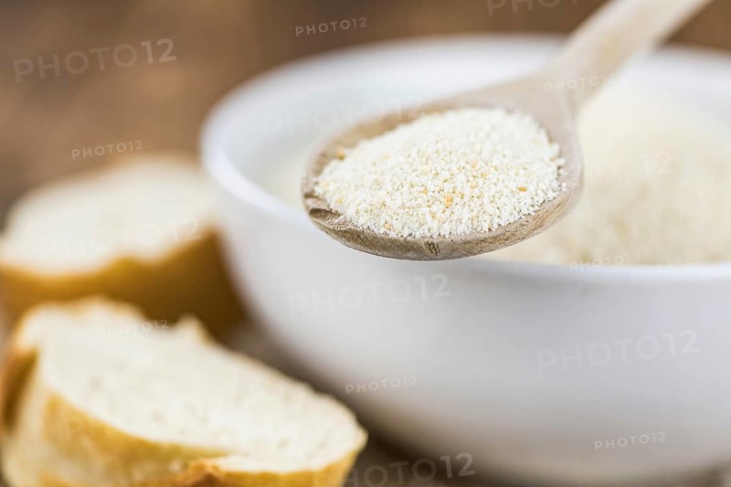 Some Bread Crumbs on a vintage wooden table (selective focus, close-up shot)