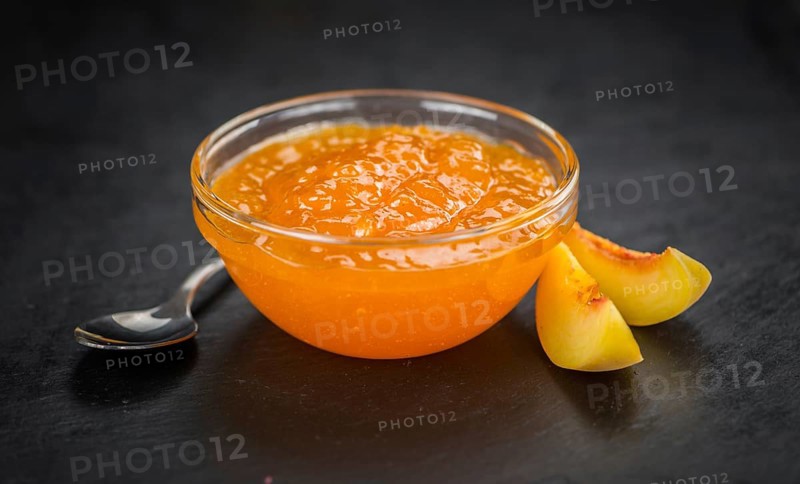 Portion of fresh Peach Jam close-up shot, selective focus