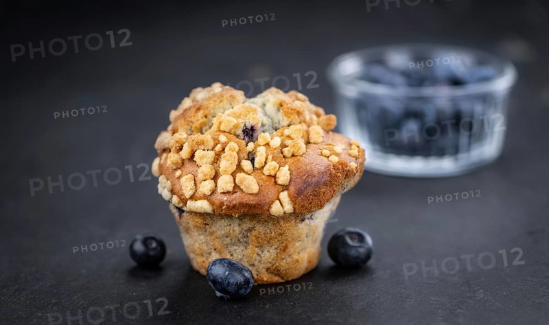 Portion of healthy Blueberry Muffins on a slate slab (selective focus)