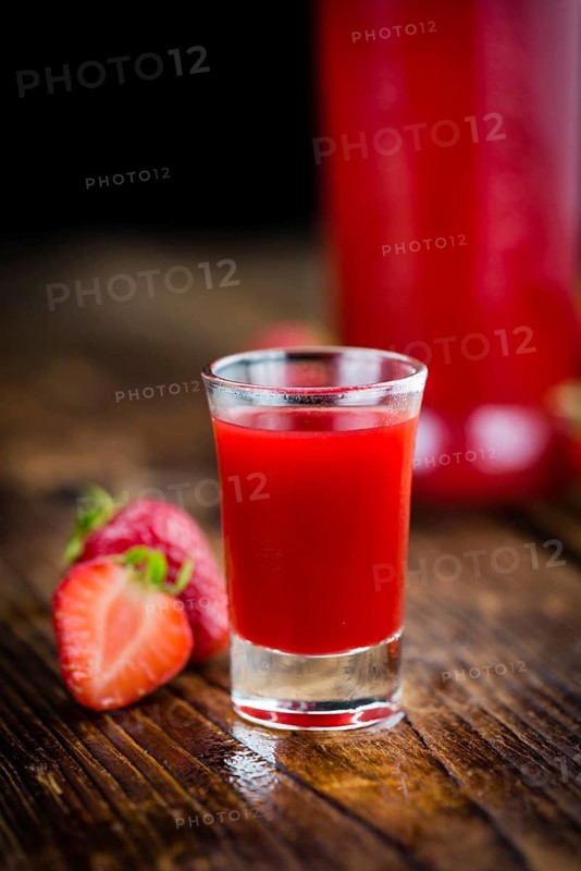 Homemade Strawberry liqueur on vintage background selective focus, close-up shot