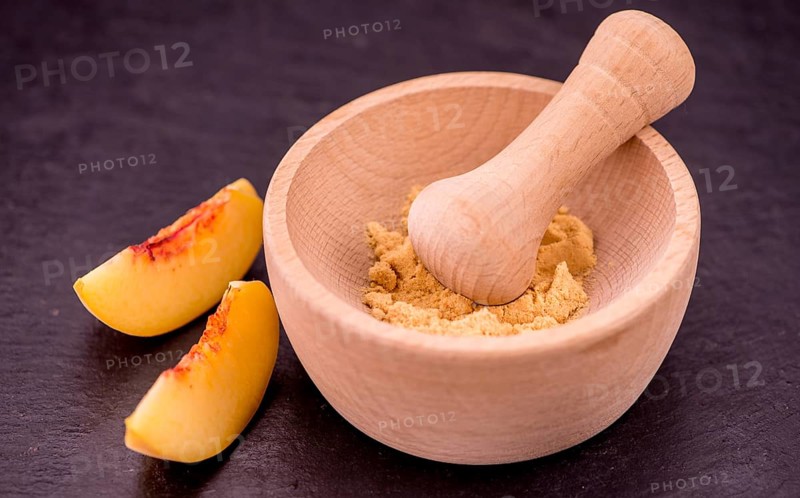 Peach powder on a vintage slate slab as detailed close-up shot, selective focus