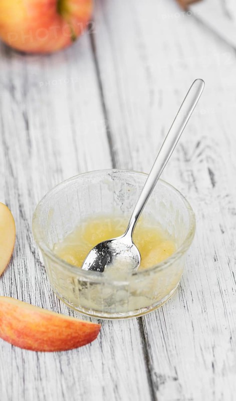 Homemade Applesauce (selective focus, close-up shot) on vintage background with some fresh fruits