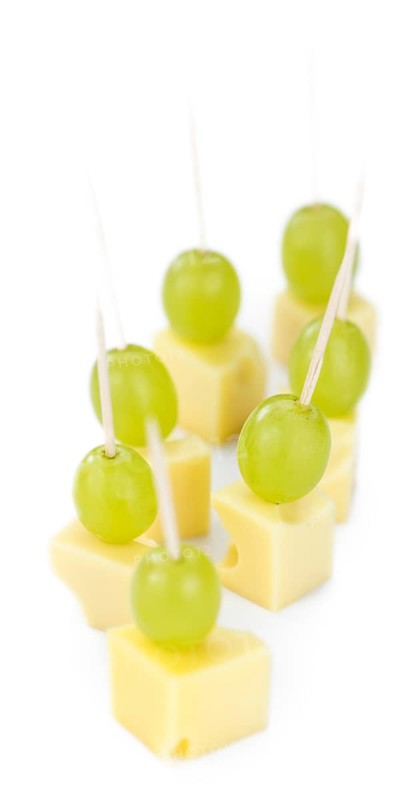 Cheese blocks with grapes isolated on white background (partyfood)