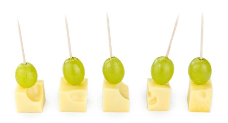 Cheese blocks with grapes isolated on white background (partyfood)