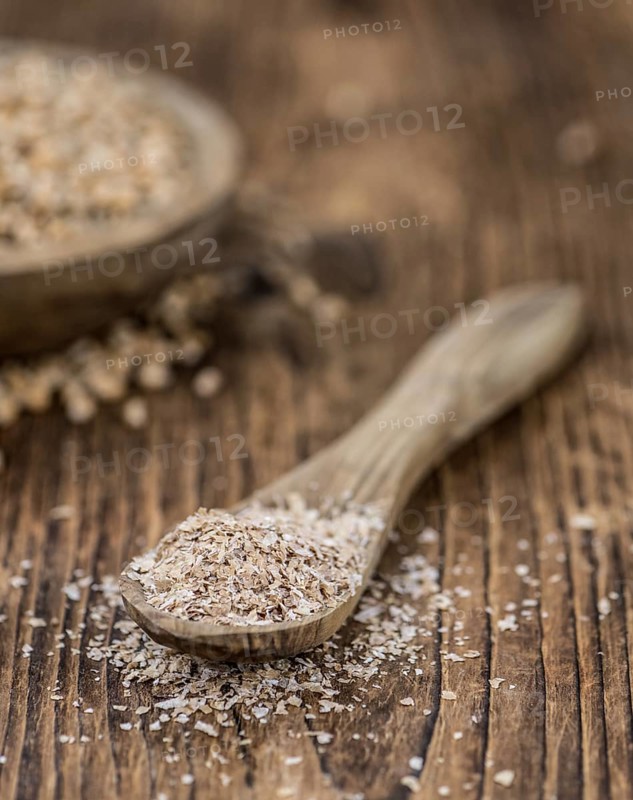 Wheat Bran on an old wooden table (selective focus)