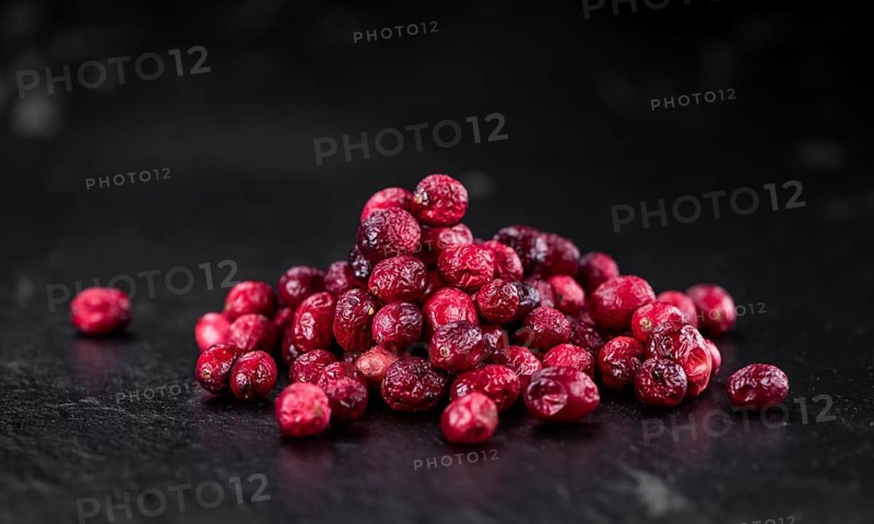 Portion of healthy Dried Cranberries on a slate slab (selective focus)