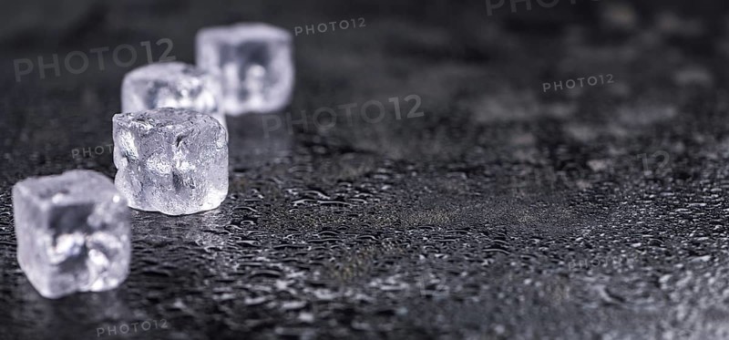 Some melting Ice cubes on a vintage slate slab (selective focus)