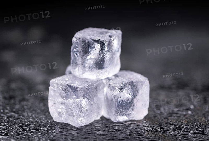 Some melting Ice cubes on a vintage slate slab (selective focus)