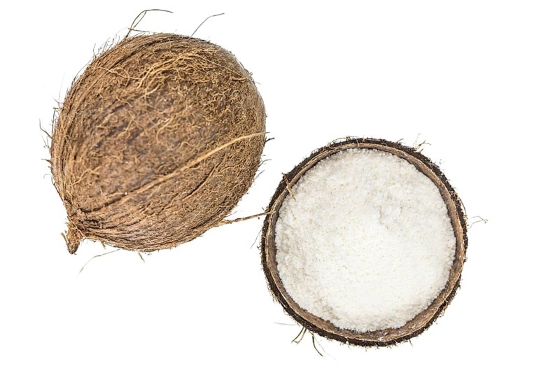 Coconut flour as detailed close-up shot isolated on white background (selective focus)