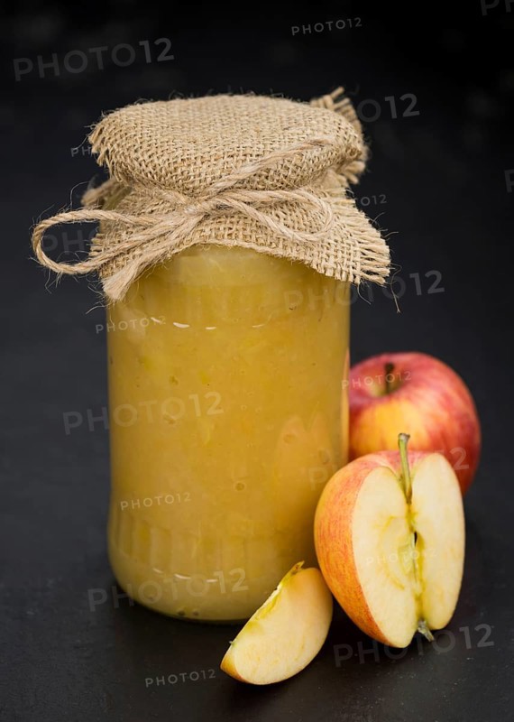 Portion of homemade Applesauce (selective focus, close-up shot) on vintage background