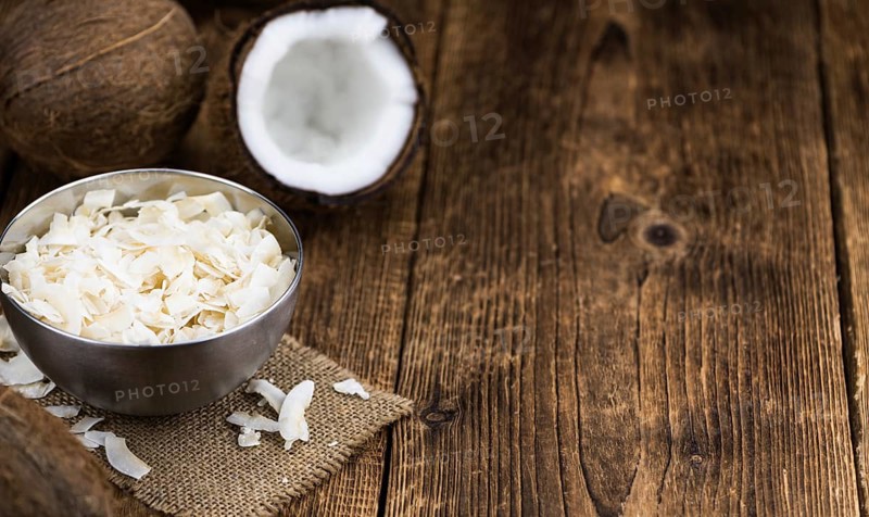 Coconut Chips (fresh) as detailed close-up shot, selective focus)