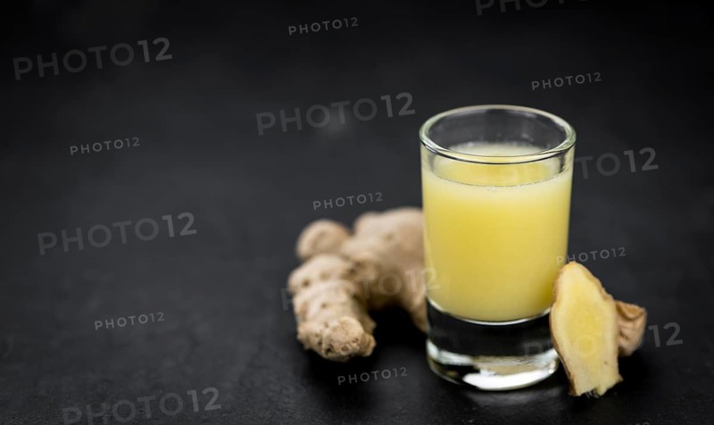 Portion of fresh Ginger Juice (selective focus, close-up shot)