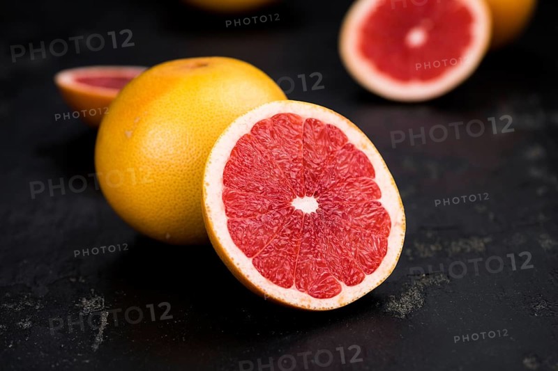 Grapefruits slices (selective focus) on a vintage background as detailed close-up shot