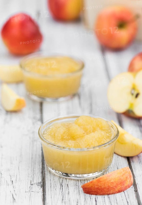 Old wooden table with fresh made Applesauce (selective focus, close-up shot)