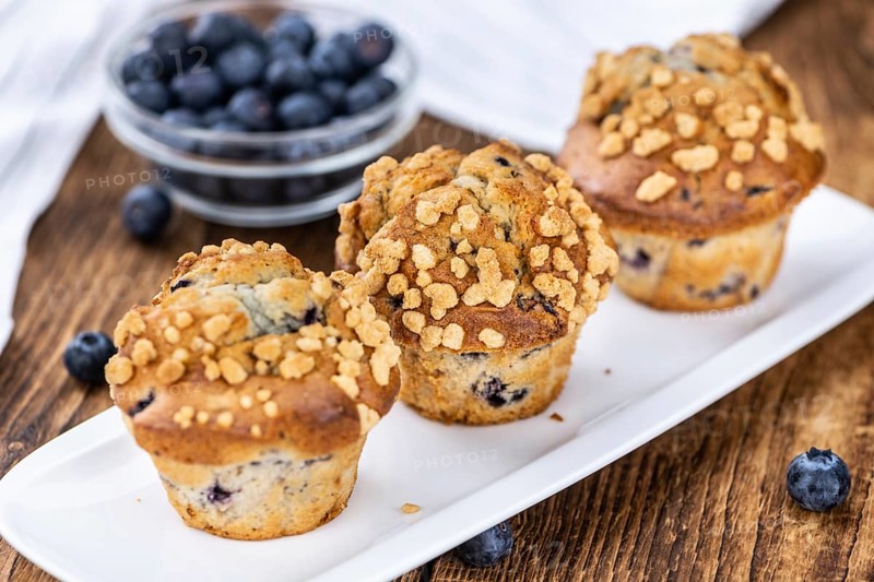 Fresh Blueberry Muffins as detailed close-up shot (selective focus)