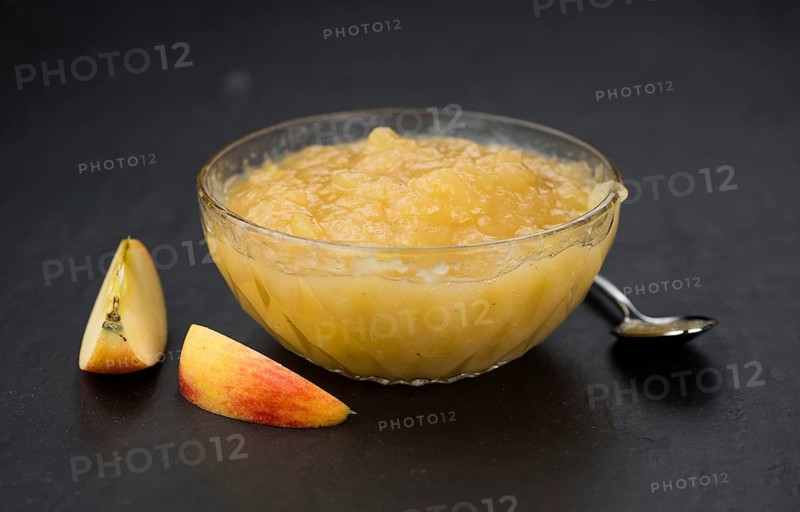 Slate slab with homemade Applesauce (close-up shot, selective focus)