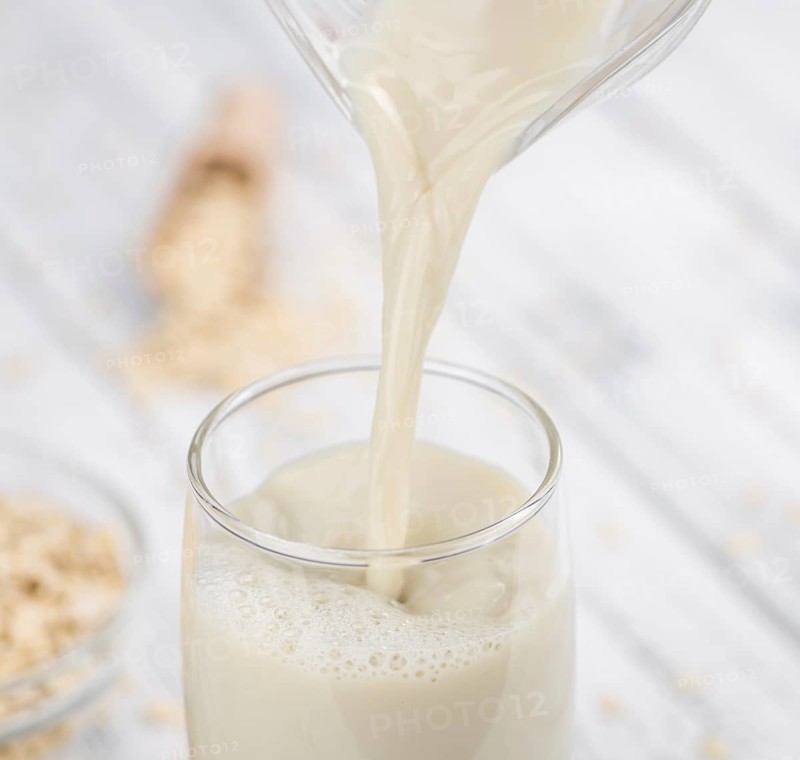Wooden table with Oat Milk (detailed close-up shot, selective focus)