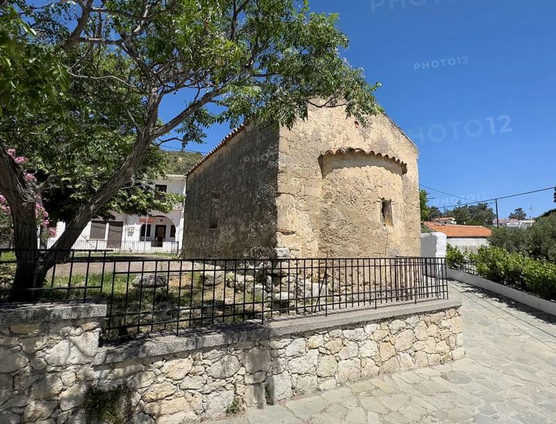 Exterior view from back with small apse of historic small single-nave church Panagia Throniotissa Naos Panagia of the Dormition of the Virgin Mary of the Assumption in Thronos built in 14th century on part of area of destroyed predecessor church Episcopal Basilica of Sybrita, Thronos, Crete, Greece, Europe