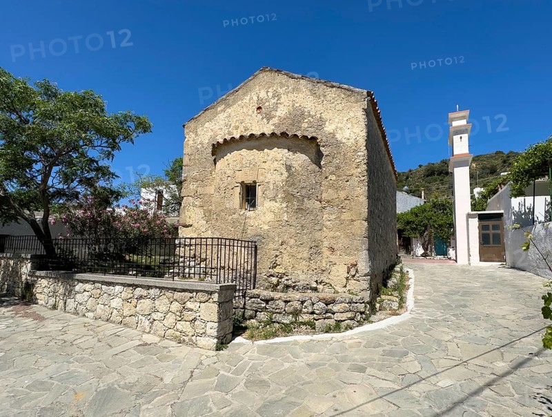 Exterior view from back with small apse of historic small single-nave church Panagia Throniotissa Naos Panagia of Dormition of the Virgin Mary of the Assumption in Thronos built in 14th century on part of area of destroyed predecessor church Episcopal Basilica of Sybrita, Thronos, Crete, Greece, Europe