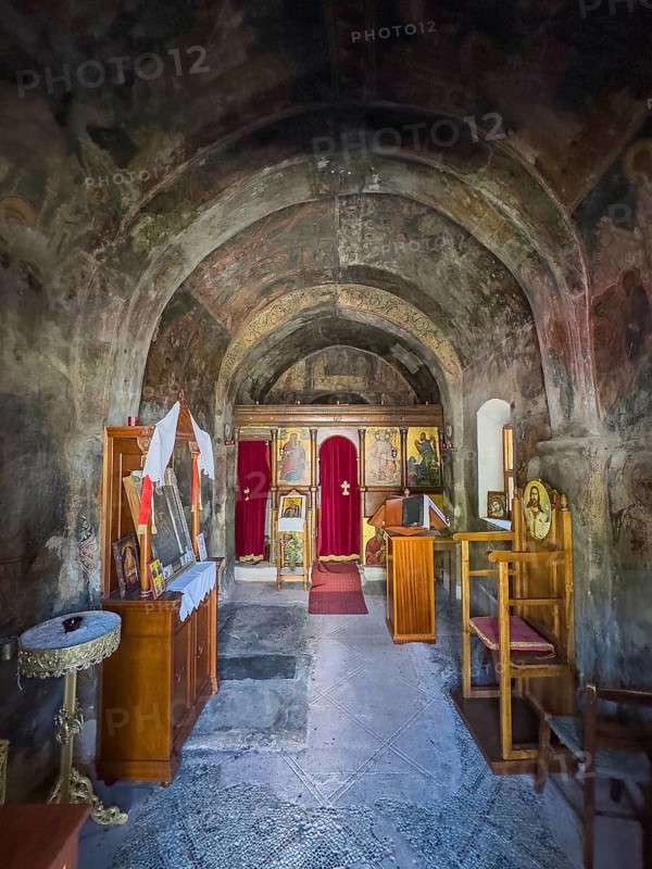Interior with antique frescoes in the historic small single-nave church Panagia Throniotissa Naos Panagia of the Dormition of the Virgin Mary of the Assumption in Thronos built in the 14th century on part of the site of the destroyed predecessor church Episcopal Basilica of Sybrita, Thronos, Crete, Greece, Europe