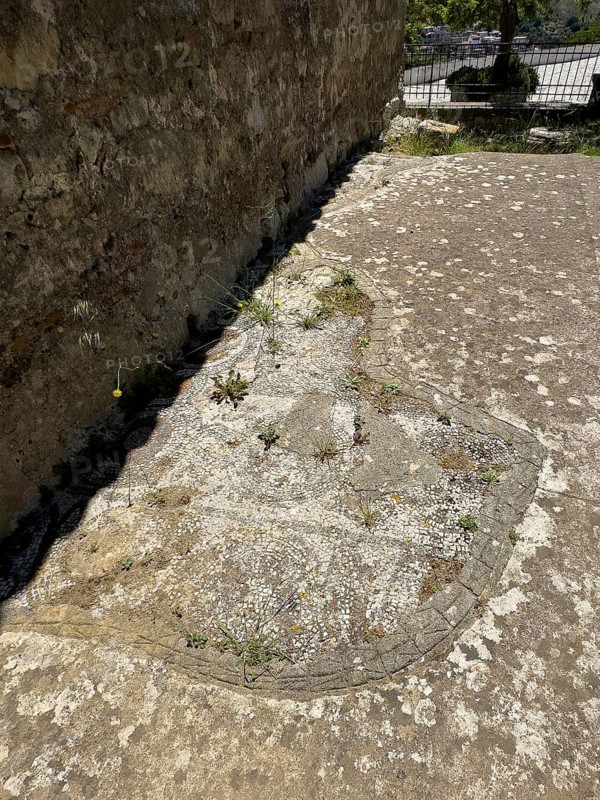 From antiquity preserved parts of floor mosaic of predecessor church Basilica of Sybrita now on exterior of historic church of Panagia Throniotissa Naos Panagia of the Dormition of the Virgin Mary of the Assumption in Thronos built in 14th century on area of destroyed predecessor church Episcopal Church Basilica of Sybrita, Thronos, Crete, Greece, Europe