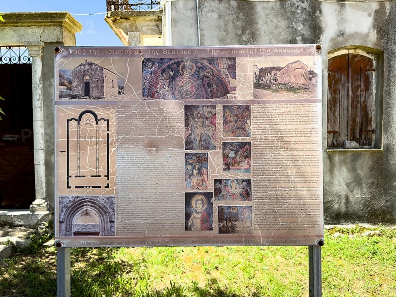 Tourist board for holidaymakers with explanation of floor plan frescoes history information in front of historic small church of Panagia Throniotissa Naos Panagia of Dormition of the Virgin Mary Assumption of in Thronos built in 14th century on area of destroyed predecessor church Episcopal Basilica of Sybrita, Thronos, Crete, Greece, Europe