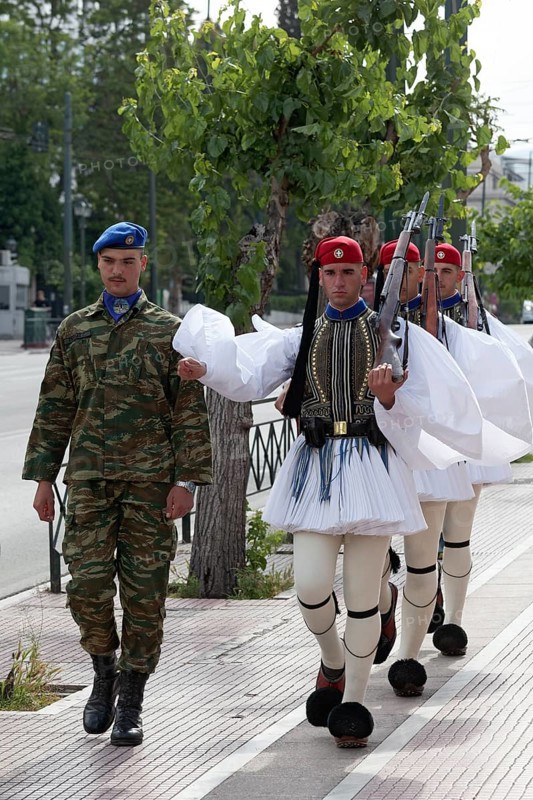 Evzones march on the pavement for the changing of the guard in front of the parliament building, Syntagma Square, Athens, Greece, Europe