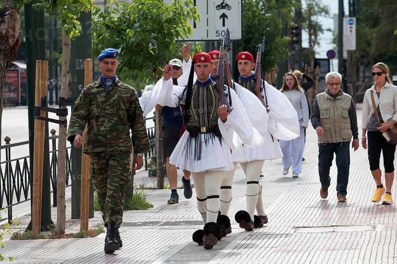 Evzones in traditional dress march to the changing of the guard in front of the parliament building, Syntagma Square, Athens, Greece, Europe