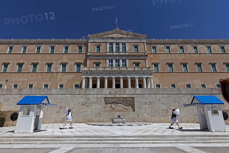 Parliament building with Evzones in traditional dress, blue sky, Athens, Greece, Europe