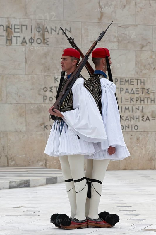 Two Evzones in traditional dress shoulder to shoulder, standing guard in front of the Parliament building, Tomb of the Unknown Soldier, Syntagma Square, Athens, Greece, Europe