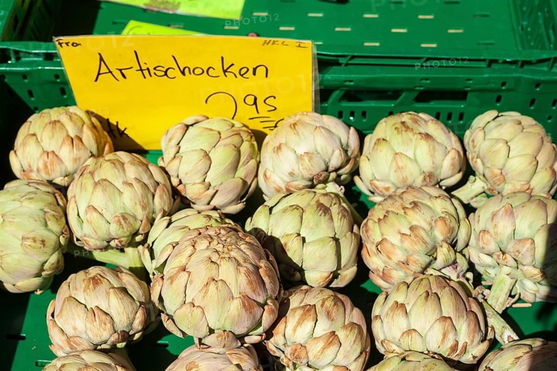 Artichokes in a crate with price tag on a market stall, Germany, Europe