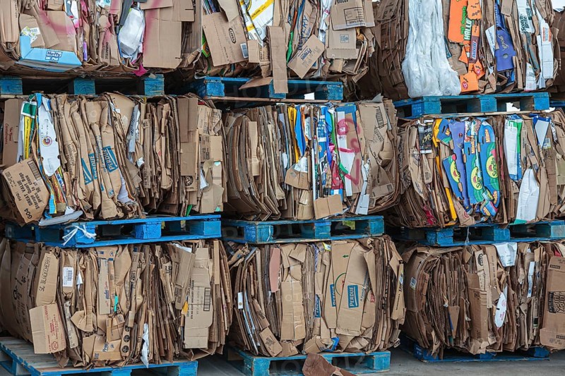 Crushed cardboard boxes bundled on pallets for recycling