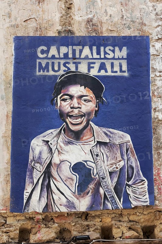 Poster critical of capitalism with a portrait of a coloured man in Exarchia, district of the students and alternative scene, Athens, Greece, Europe