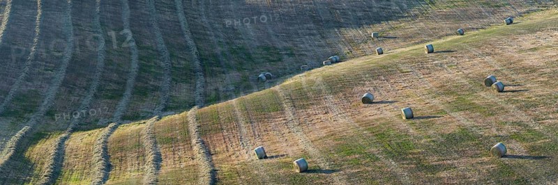 Harvested wheat field with bales of straw, landscape around Pienza, Val d'Orcia, Orcia Valley, UNESCO World Heritage Site, Province of Siena, Tuscany, Italy, Europe