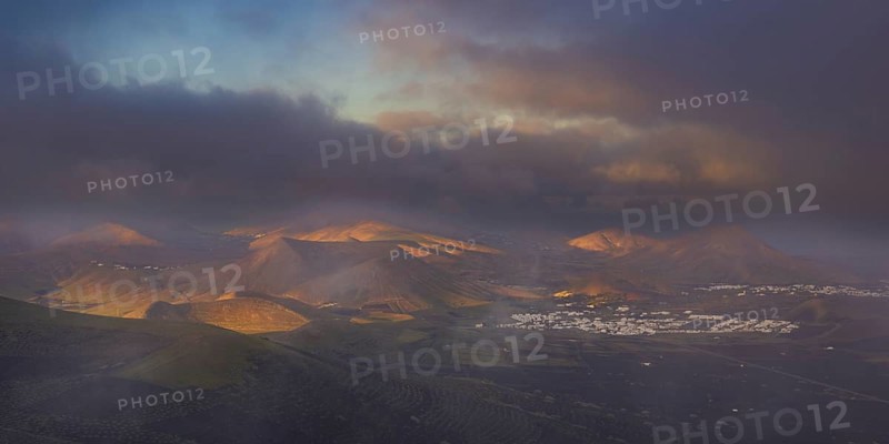 Panorama at sunrise from Montana de Guardilama to the wine-growing region of La Geria, with the villages of Uga and Yaiza behind, Lanzarote, Canary Islands, Spain, Europe