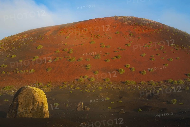 Lava bomb in front of Caldera Colorada, Parque Natural de Los Volcanes, near Masdache, Lanzarote, Canary Islands, Spain, Europe
