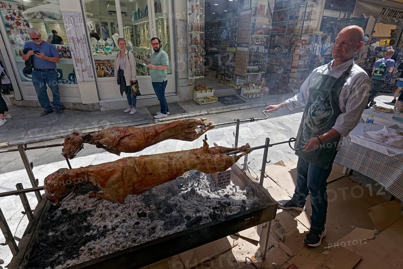 Man grilling lambs on a spit in front of a taverna, Easter lamb, Plaka neighbourhood, Athens, Greece, Europe