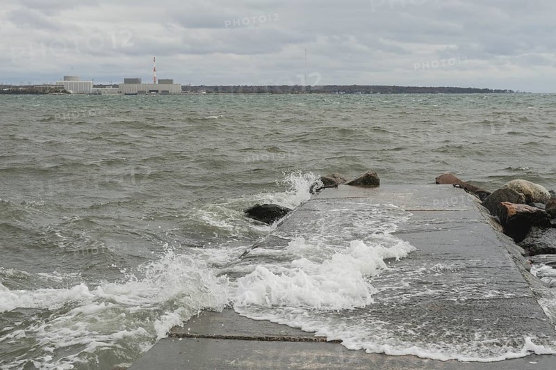 Black Point Beach, Niantic, East Lyme, Connecticut USA 28 Oct 2012: Winds, whitecaps and heavy surf build along the Connecticut shore the day before Hurricane Sandy hit coastal New England. The Millstone Nuclear Power Plant is seen across the bay