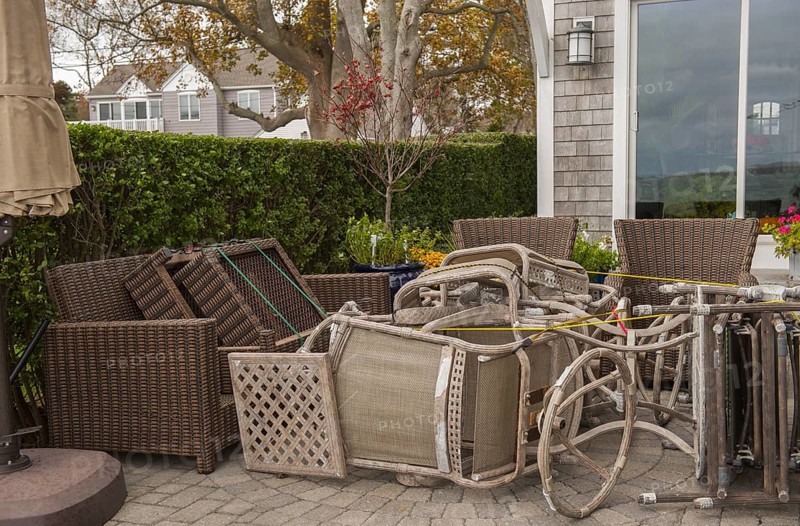 Tied down patio furniture at a house along a Connecticut USA beach for protection against Hurricane Sandy