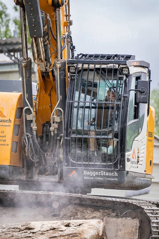 Excavator during demolition, breaking up concrete. The driver is visible in the cab, demolition site, Saarbrücken, Germany, Europe